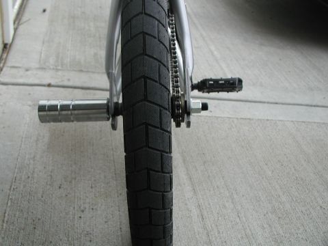 1998 Jeep TJ - Close-up of a bicycle's rear wheel, chain, and pedal assembly.