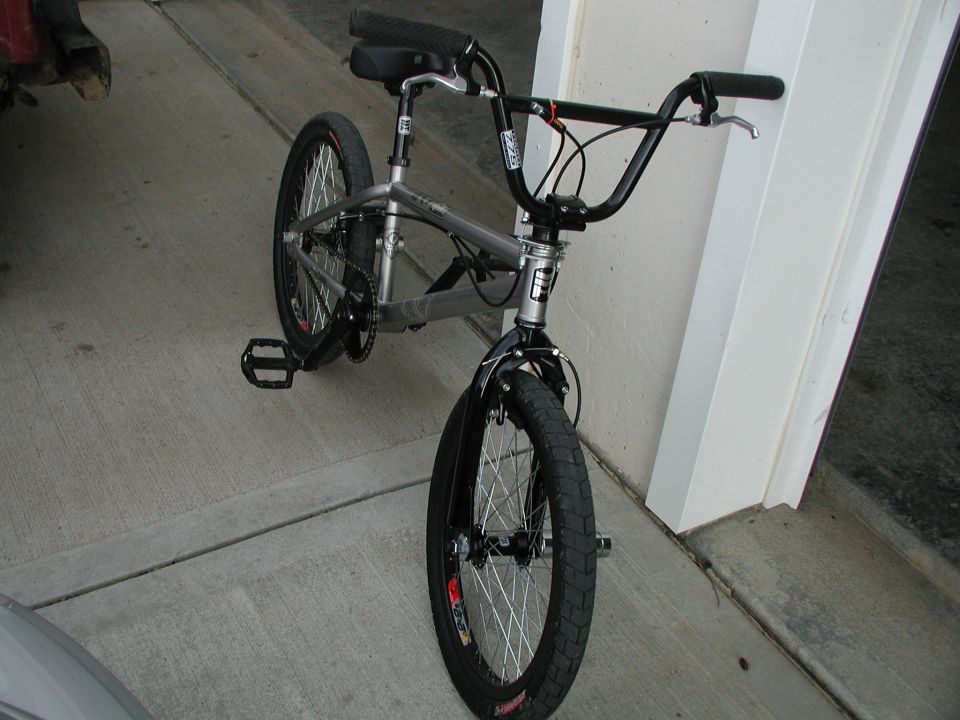 BMX bicycle parked on concrete, front wheel visible