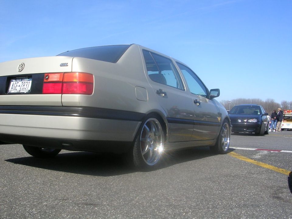 Silver sedan's rear quarter panel and taillight, 1993