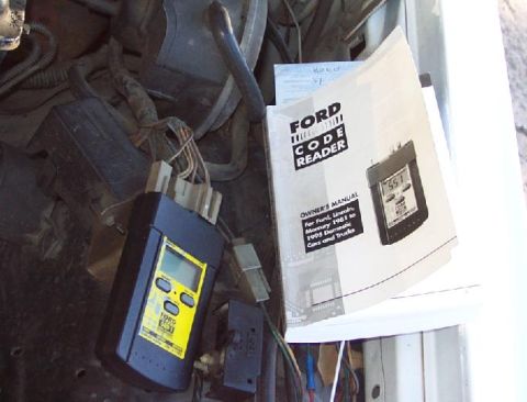 1985 Ford Crown Victoria LTD - A Ford code reader and its owner's manual are shown, detailing compatibility with vehicles from 1981 to 1993.