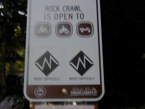 1978 Ford Bronco - A sign displays icons for vehicles allowed on a rock crawl trail.