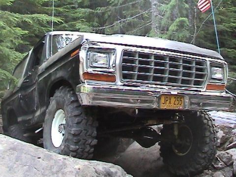 1978 Ford Bronco - This 1978 Ford Bronco navigates rocky terrain with its distinctive grille and aggressive off-road tires.