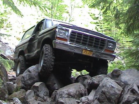 1978 Ford Bronco - This 1978 Ford Bronco navigates a challenging rocky terrain in a forest.
