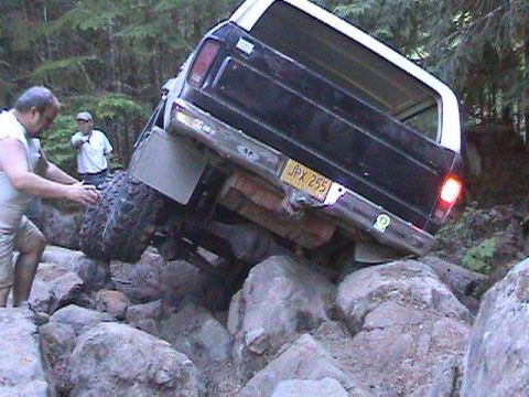 1978 Ford Bronco - A 1978 Ford Bronco is shown navigating a difficult rocky terrain with two people nearby.