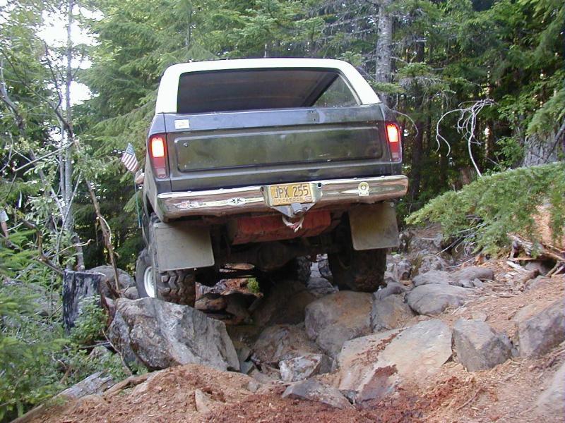Rear view of a 1978 Ford Bronco navigating a rocky off-road trail