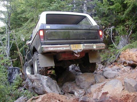 1978 Ford Bronco - This 1978 Ford Bronco is navigating a challenging rocky path in a forest setting.