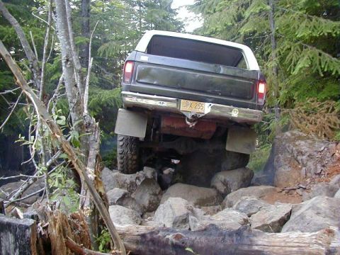 1978 Ford Bronco - This 1978 Ford Bronco is shown from the rear as it maneuvers over a challenging rock obstacle.