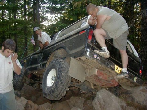 1978 Ford Bronco - This 1978 Ford Bronco is shown off-roading over large rocks with assistance from its occupants.