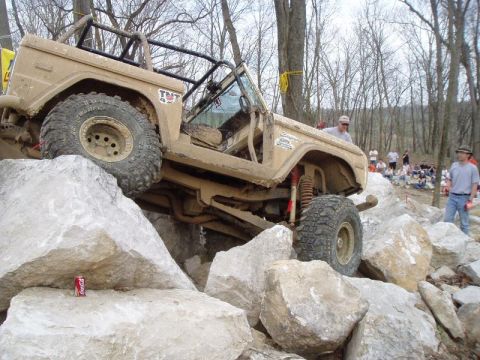 1992 Ford Bronco - A modified off-road vehicle navigates a challenging rocky terrain during an event.