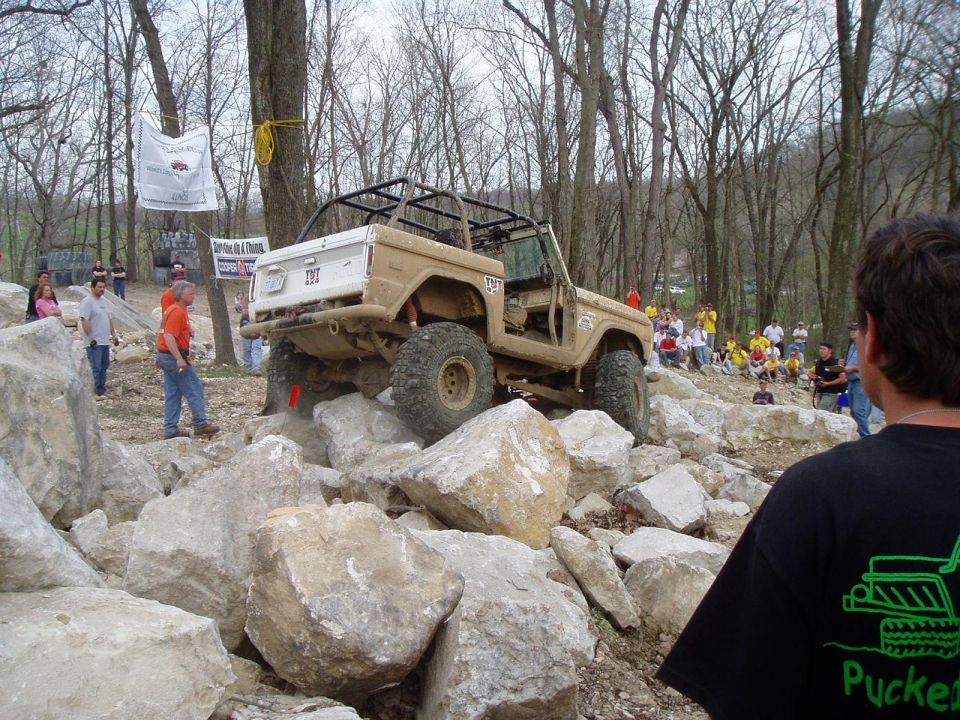 Tan 1992 Ford Bronco navigating a rocky off-road course