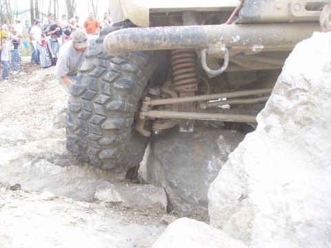 1992 Ford Bronco - A vehicle navigates a rocky obstacle course with spectators observing the action.