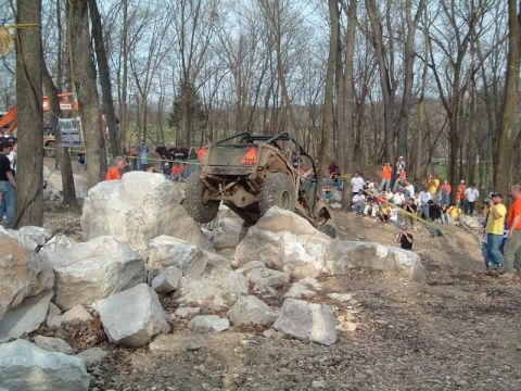 1992 Ford Bronco - A custom off-road vehicle tackles a challenging rock climb during an event.