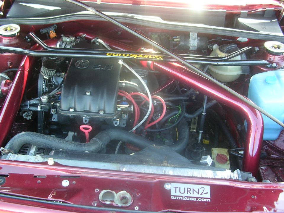 Engine bay with "Eurospart" strut bar and "2.0" engine cover