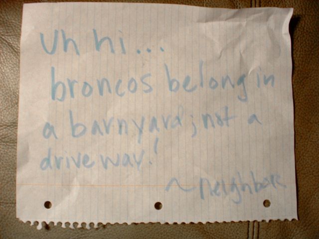 Handwritten note stating 'broncos belong in a barnyard, not a driveway!'