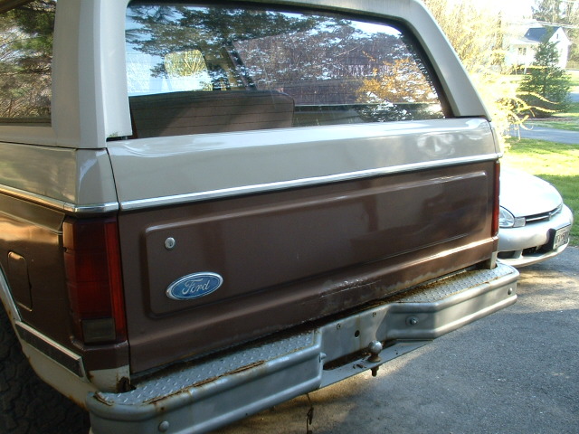 Rear of a brown and tan 1982 Ford Bronco with a Ford badge
