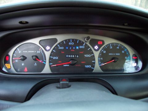 1999 Ford Taurus - The instrument cluster of a 1999 Ford Taurus shows 90,616 miles and several illuminated warning lights, including service engine soon.