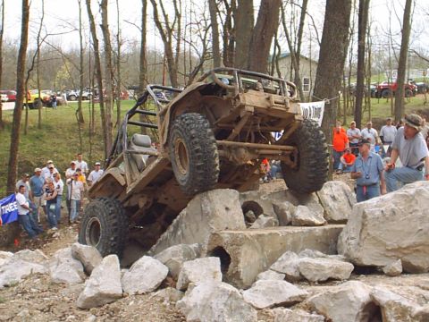1992 Ford Bronco - Custom off-road buggy navigates a challenging obstacle course with spectators observing.