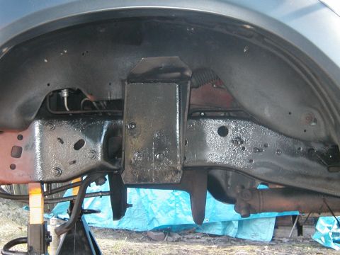 1994 Ford Bronco - The underside of a vehicle is shown, with the frame and suspension components visible.