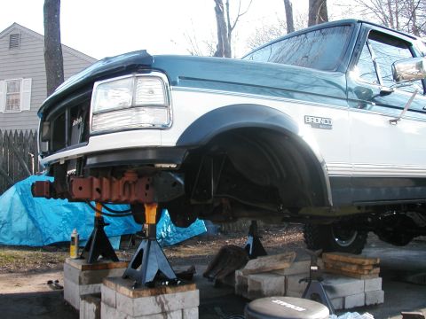 1994 Ford Bronco - Front end of a 1994 Ford Bronco is raised on jack stands for repairs.