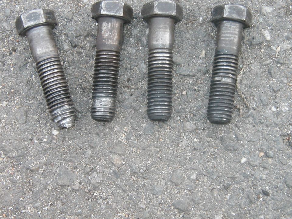 Four bolts on asphalt