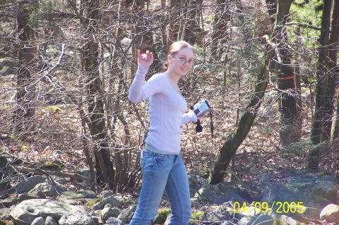 1979 Ford Bronco - A woman walks through a rocky, wooded area holding a camcorder.