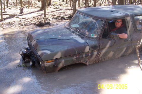 1979 Ford Bronco - This 1979 Ford Bronco is stuck deep in the mud, with its front end submerged in water.