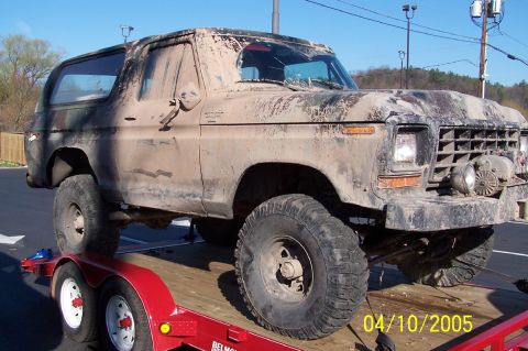 1979 Ford Bronco - This heavily mud-caked 1979 Ford Bronco is being transported on a trailer.