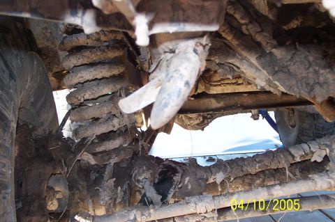 1979 Ford Bronco - The heavily soiled undercarriage of a vehicle reveals its extensive use on rough terrain.