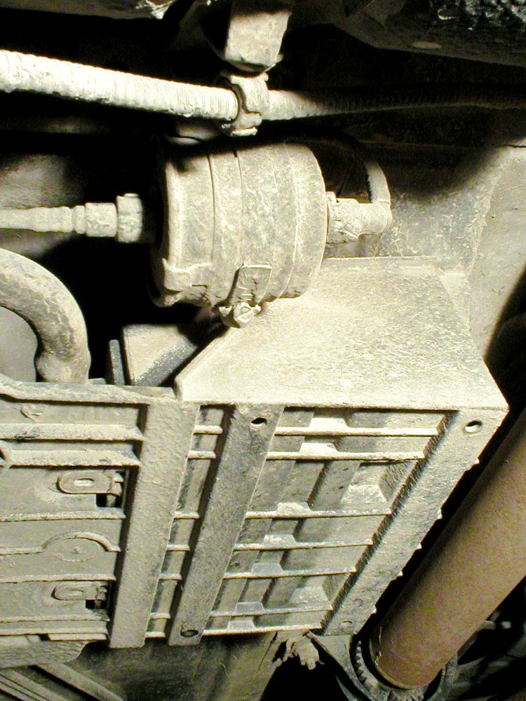 3) Locate the fuel filter underneath the vehicle.
It will be on the driver’s side, inboard from the rear passenger door, and fitted up against the floorpan.
