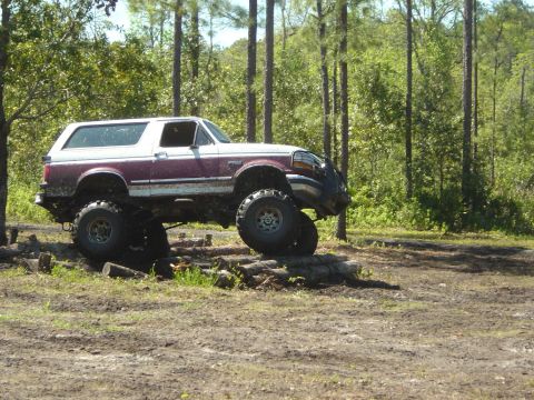 1993 Ford Bronco - Modified 1993 Ford Bronco navigating an obstacle course in the woods.