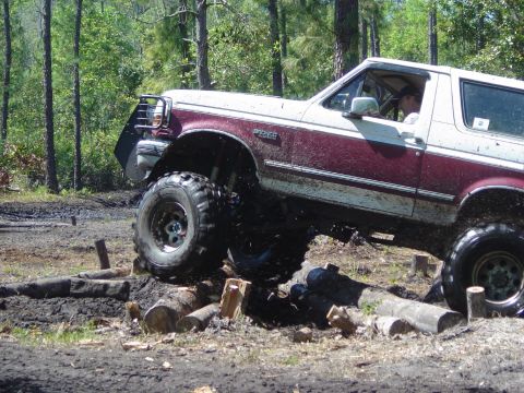 1993 Ford Bronco - This lifted 1993 Ford Bronco tackles an obstacle course of logs and mud.