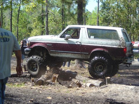 1993 Ford Bronco - This 1993 Ford Bronco is navigating an obstacle course made of logs and mud.