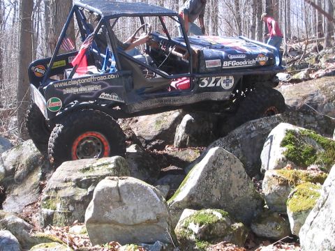 1995 Ford Bronco - This heavily modified off-road vehicle tackles a challenging rocky terrain.