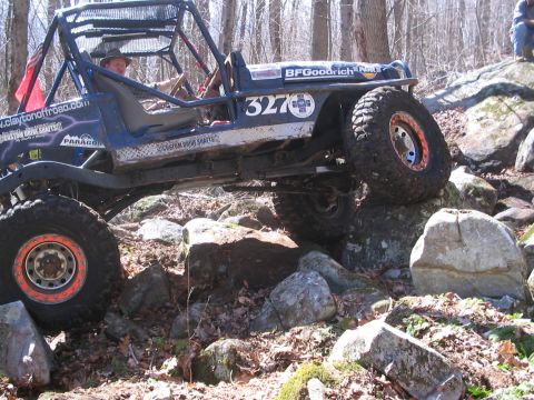 1995 Ford Bronco - Custom off-road buggy tackling a challenging rocky trail.