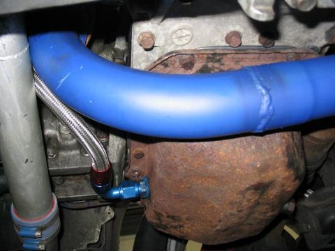 1993 Ford Probe - This is a close-up view of a vehicle's engine oil pan and a blue hose.