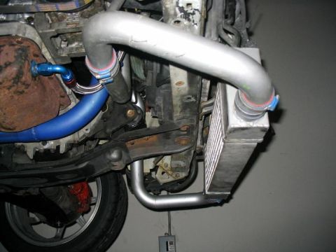 1993 Ford Probe - Close-up view of an intercooler and custom piping installed on a vehicle.