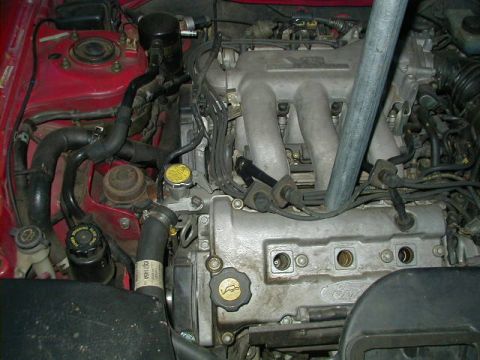1993 Ford Probe - Close-up of a Ford engine bay, showing the valve cover with Ford branding and various engine components.