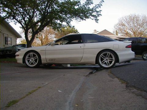 1993 Ford Probe - A white 1993 Ford Probe GT is parked on the side of a residential street.