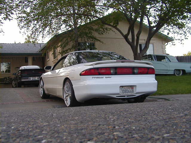 White 1993 Ford Probe coupe, rear 3/4 view, parked in driveway