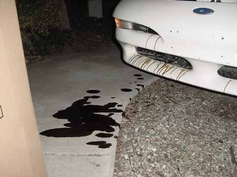 1993 Ford Probe - Oil is leaking from the front of this 1993 Ford Probe onto the driveway.