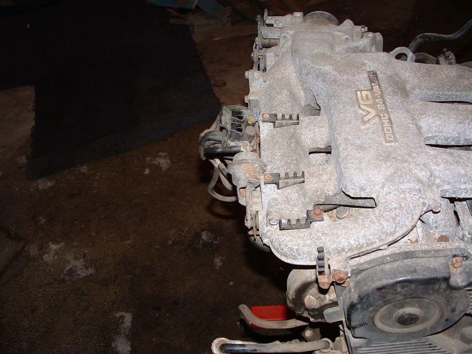 Close-up of a V6 DOHC 24-Valve engine intake manifold, possibly from a Mazda or Ford