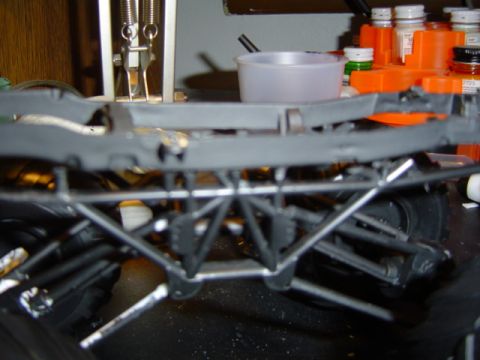 1979 Ford Bronco - The underside of a model vehicle chassis shows intricate suspension details and tires.