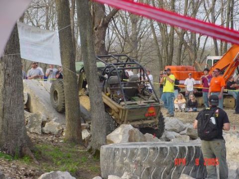1992 Ford Bronco - Off-road buggy attempts an obstacle course with spectators observing the action.