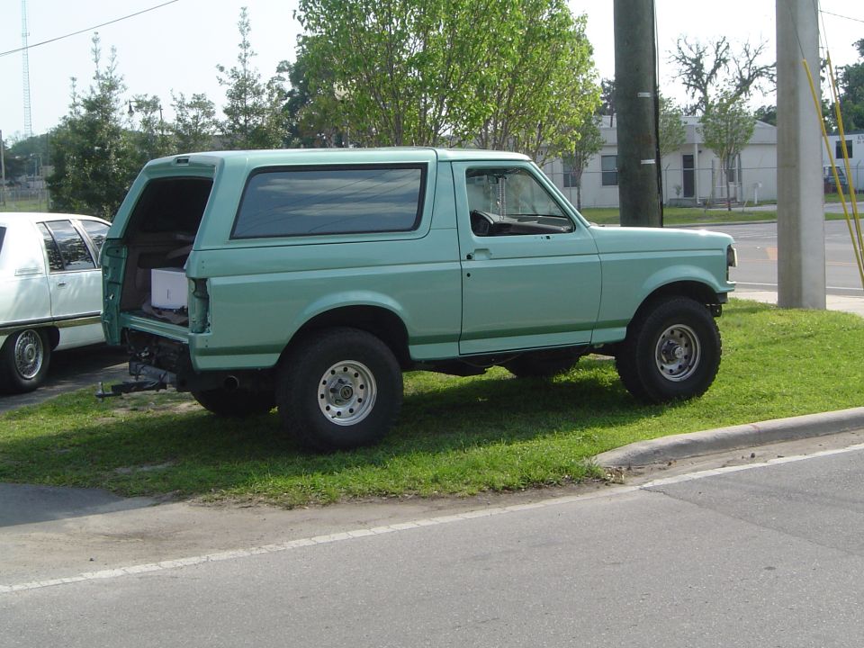 Teal green Ford Bronco rear three-quarter with tailgate open