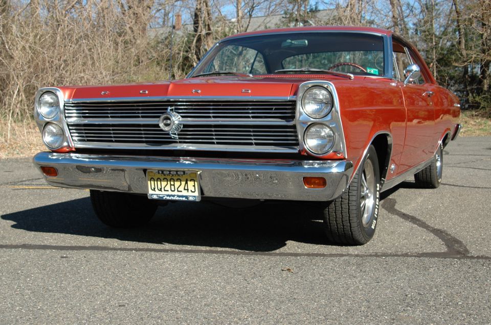 Red 1966 Ford Fairlane two-door hardtop front three-quarter view on pavement