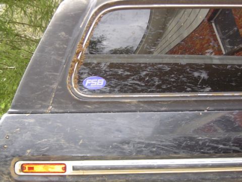 1979 Ford Bronco - This vehicle's rear quarter panel and window are covered in dirt and debris.