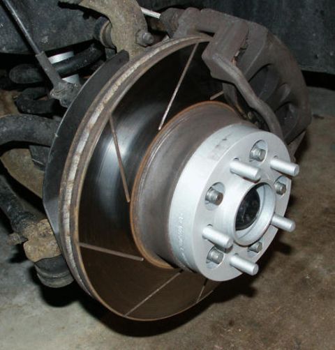 2001 Mercury Grand Marquis - Wheel spacer installed on a vehicle's brake rotor and hub assembly.