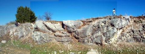 1996 Ford Bronco - A panoramic view of a rocky landscape with several individuals exploring the terrain under a bright blue sky.