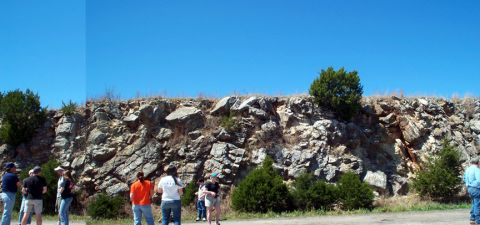 1996 Ford Bronco - A group of people stand near a rocky geological formation on a sunny day.
