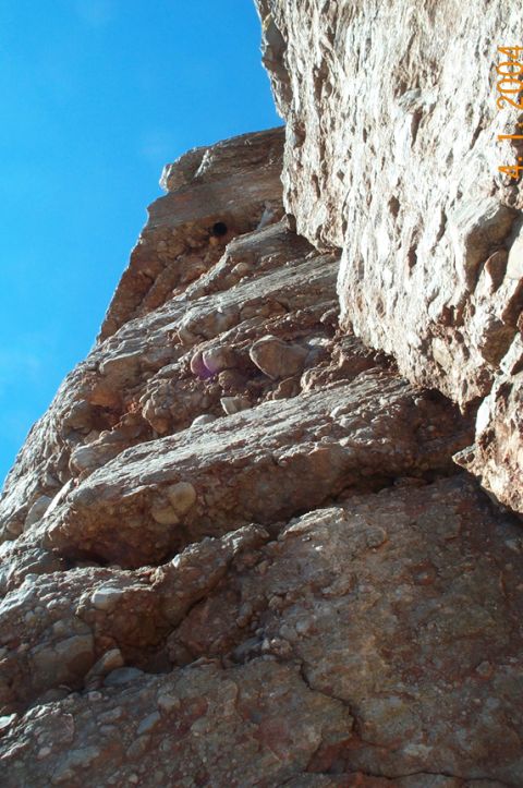 1996 Ford Bronco - Rocky cliff face with blue sky above, and a website URL visible at the bottom.